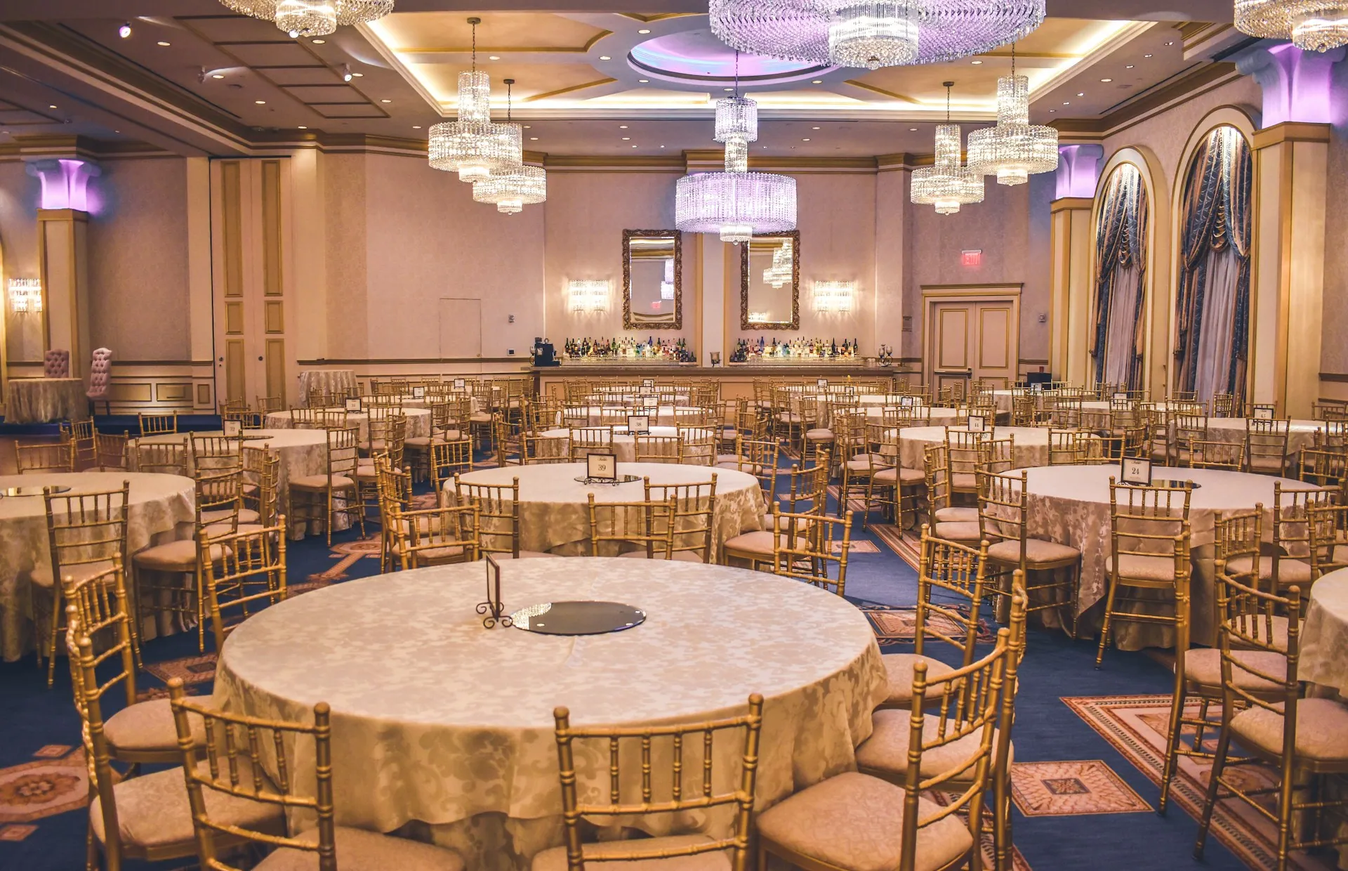 A ballroom laid with round tables for an awards gala dinner